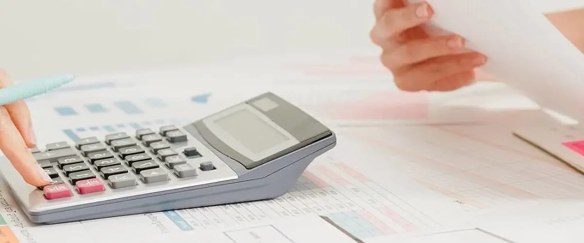 Principais impostos sobre transporte de cargas: uma pessoa calcula na calculadora